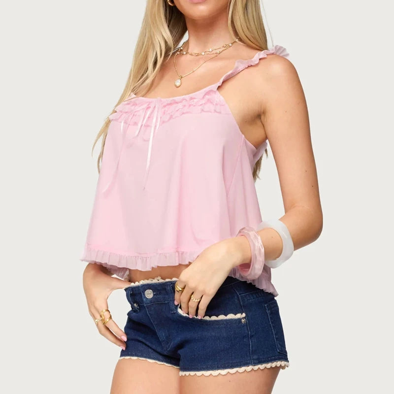 Woman wearing a pink top and denim shorts - side
