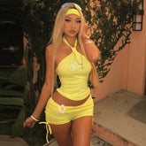 Women's halter rhinestone crop top and drawstring shorts co-ord set in yellow or black.