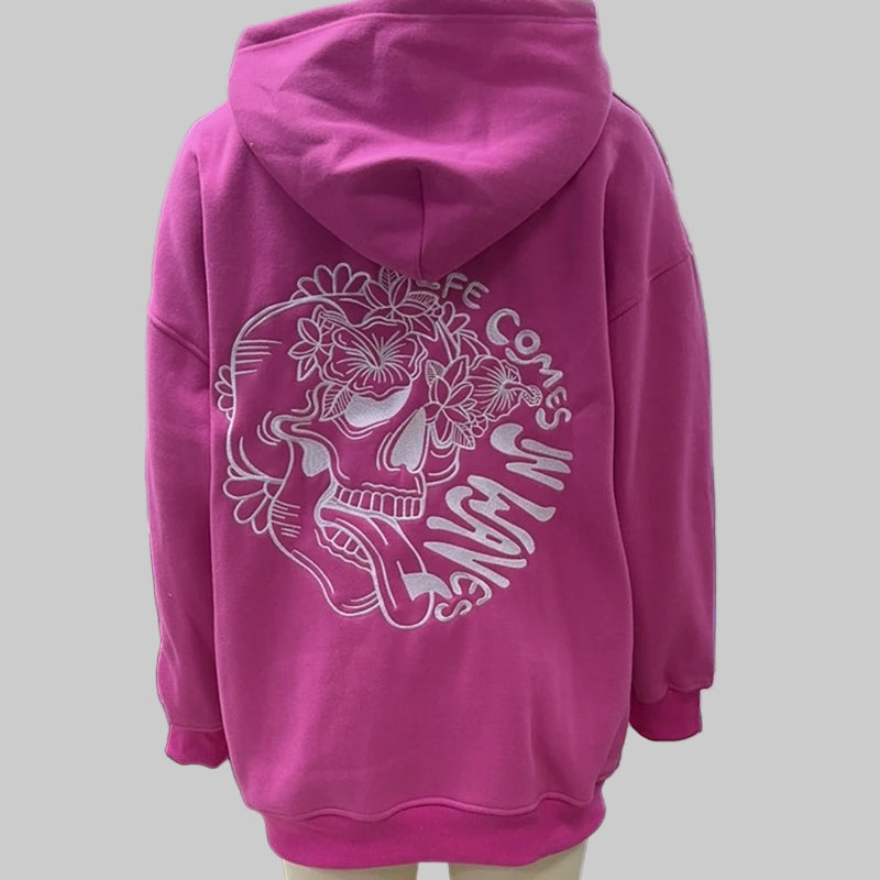 Pink hoodie with a skull design and text on a mannequin