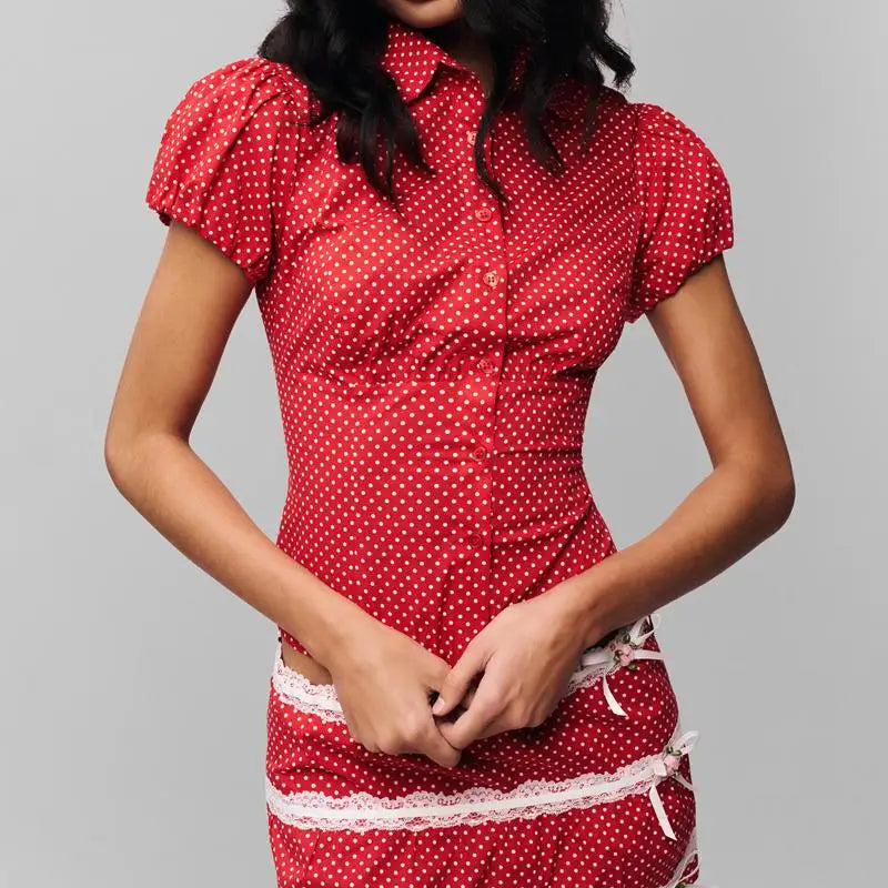 Women's polka dot button down lapel top with puff sleeves.