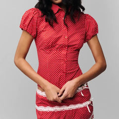 Women's polka dot button down lapel top with puff sleeves.