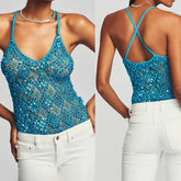 Blue sequin tank top worn by a model on a plain background