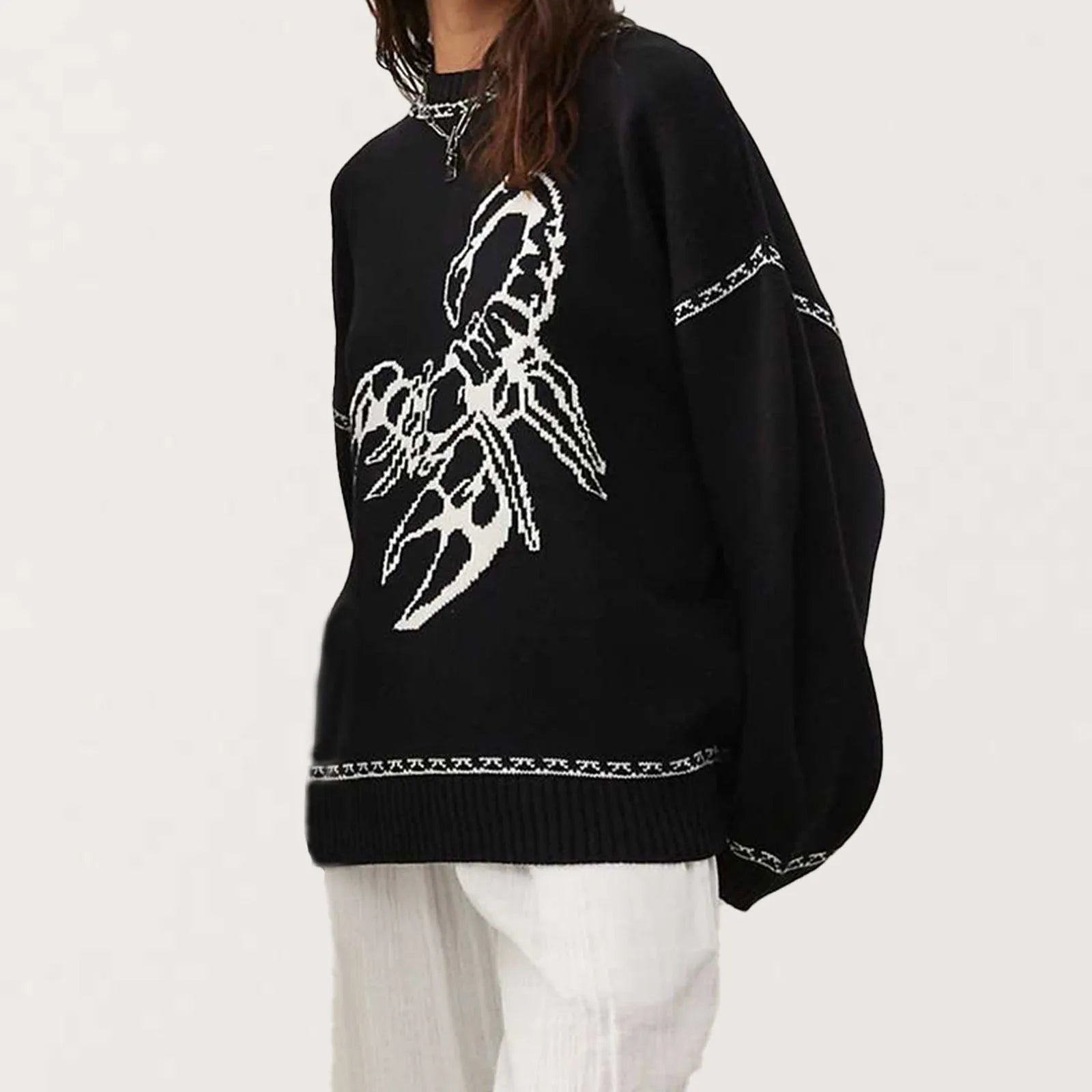 Black sweater with white scorpion design on a white background