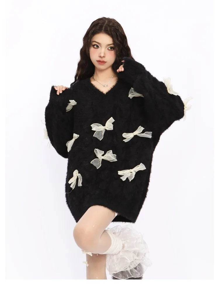 Woman wearing a black sweater with white bow patterns