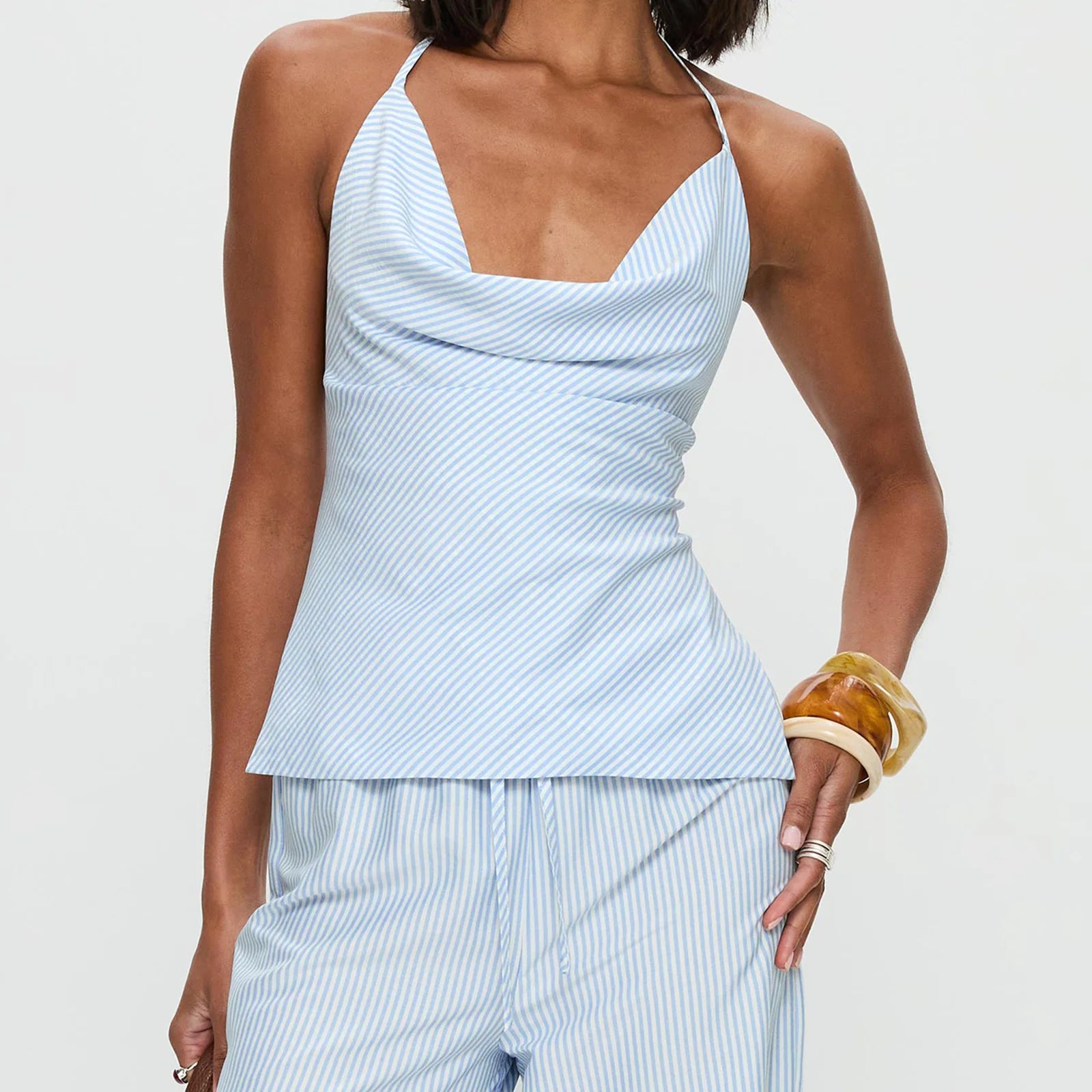 Woman wearing a light blue striped top and pants