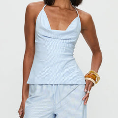 Woman wearing a light blue striped top and pants