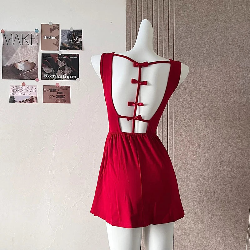 Red dress on a mannequin against a wall with posters