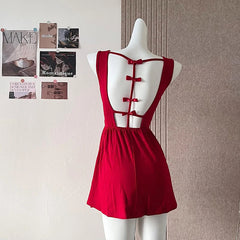 Red dress on a mannequin against a wall with posters