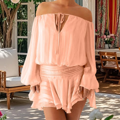 Person wearing a peach off-shoulder dress in an outdoor setting