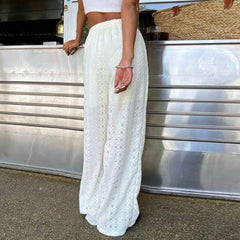 Person wearing a white lace skirt standing in front of a metallic surface.