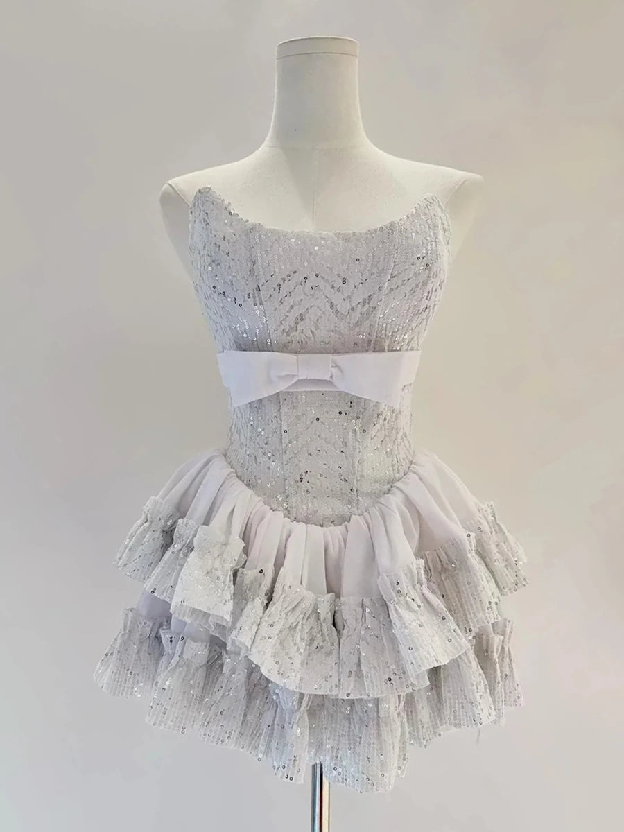 Dance costume with silver top and ruffled skirt on a mannequin