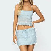 Women's halter tiered tank top and matching rise lace mini skirt set.