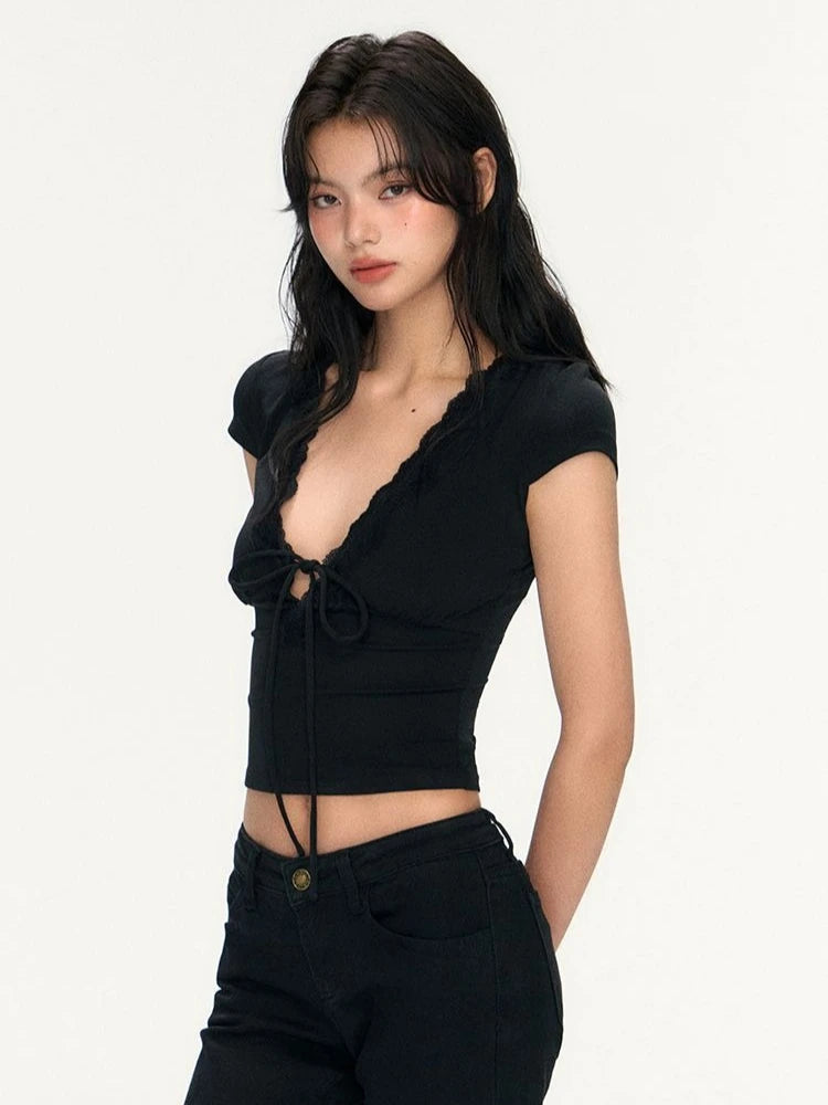 Woman wearing a black crop top and black pants