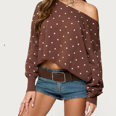 Brown polka dot top worn by a person -close-up