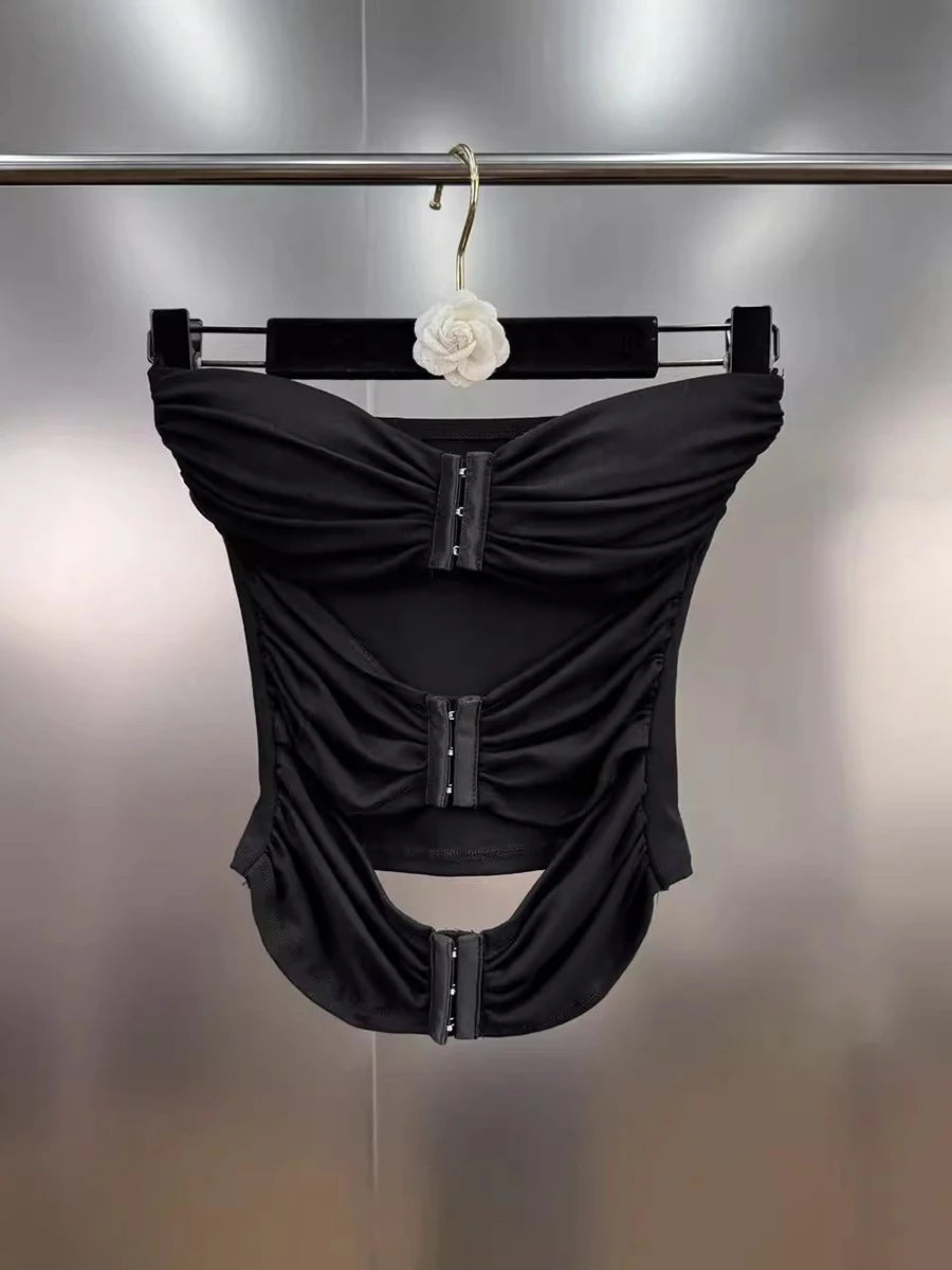 Women's black strapless spliced top with metal buckle detail.