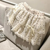 Women's white polka dots elastic mini skirt with a bow.
