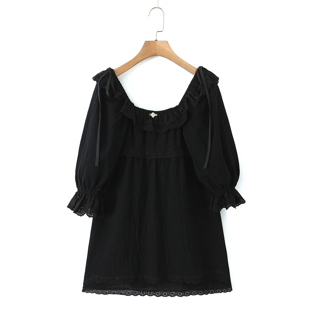 Black dress with ruffled sleeves on a wooden hanger- round ruffles neckline