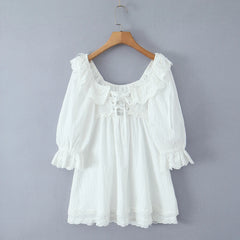 White lace dress on a wooden hanger - back view, lace details