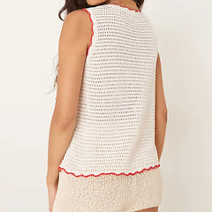 White sleeveless top with red trim on a plain background