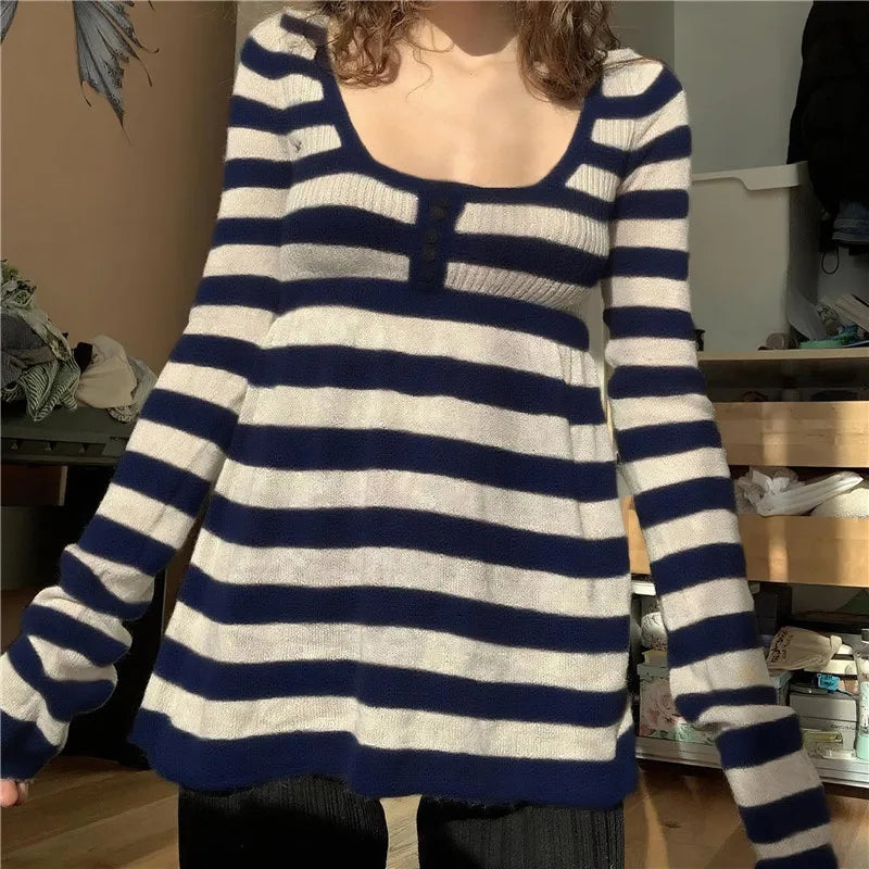 Person wearing a blue and white striped sweater in an indoor setting