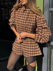 Woman wearing a brown houndstooth pattern outfit with sheer stockings.