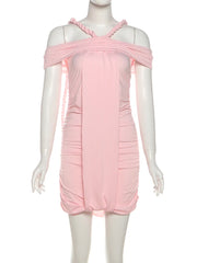 Pink dress on a mannequin against a white background