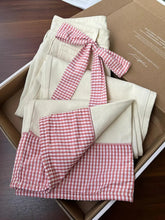 jeans with red and white checkered pattern on a brown surface