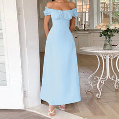 Woman wearing a light blue off-shoulder dress in a home setting.