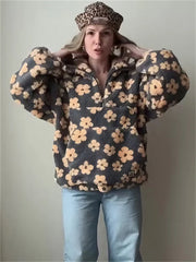 Person wearing a floral patterned jacket and light blue jeans against a plain background