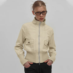 Woman wearing a beige jacket against a plain background