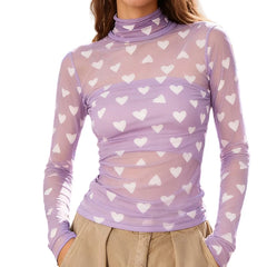Purple long-sleeve top with white heart patterns