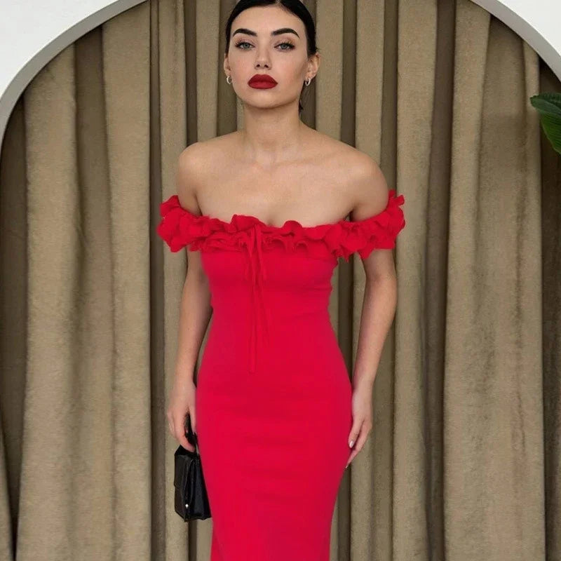 Woman wearing a red off-shoulder dress against a beige curtain background