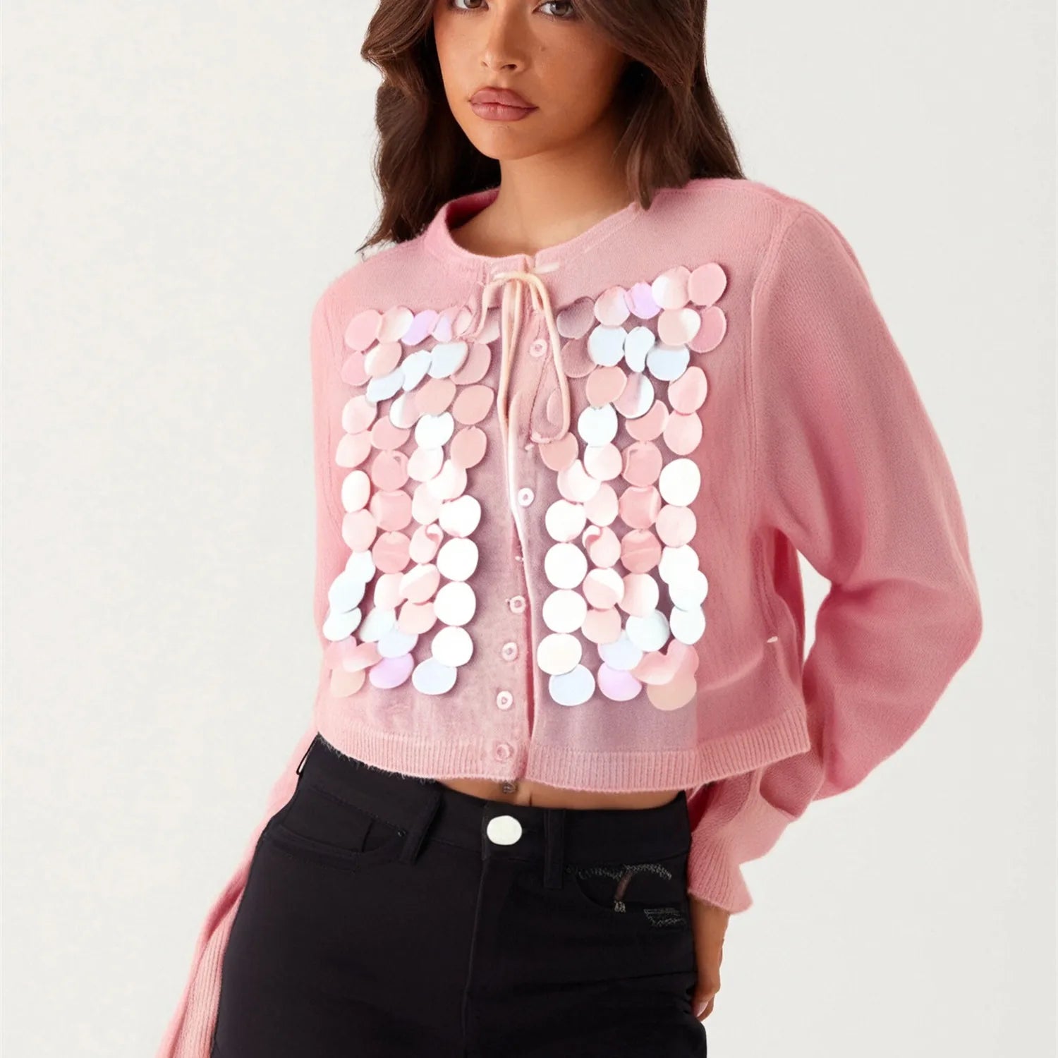 Pink cardigan with sequin embellishments worn by a model