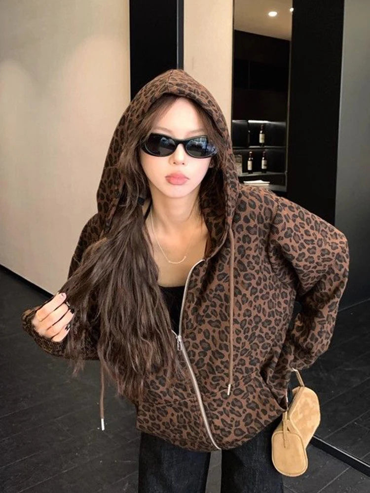 Person wearing a leopard print hoodie in an indoor setting