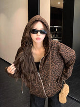 Person wearing a leopard print hoodie in an indoor setting