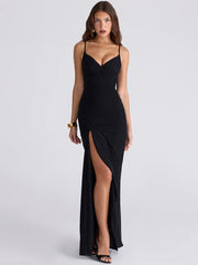 Woman wearing a black evening gown with a slit