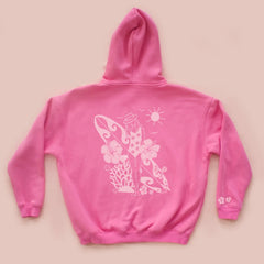 Pink hoodie with white graphic design on a beige background