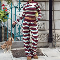 Person wearing a striped outfit with a dog on a leash in an urban setting