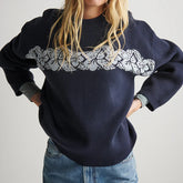 Navy sweatshirt with lace detail worn by a person on a plain background