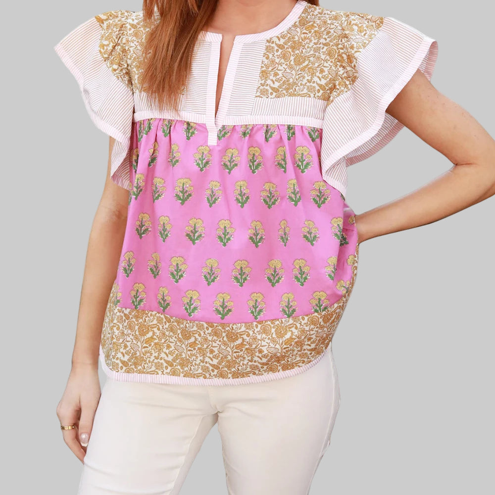 Woman wearing a colorful top with floral patterns