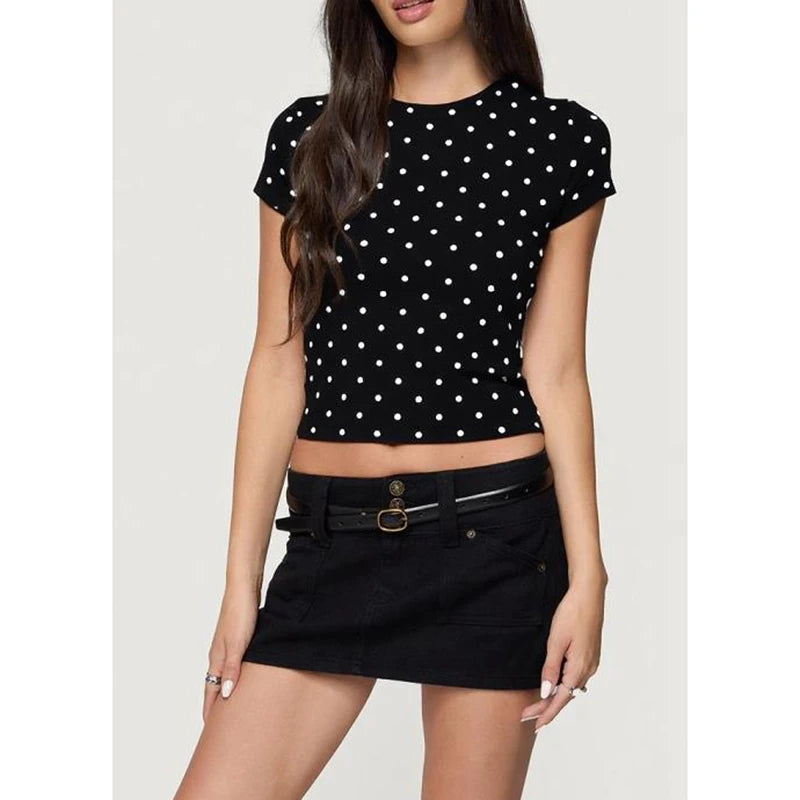 Woman wearing a black polka dot top and black skirt
