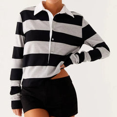 Black and white striped long-sleeve shirt worn by a person on a light gray background