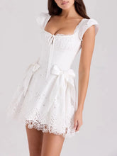 Women's white solid mini dress with a corset-style bodice, ruffled straps, and an A-line skirt.