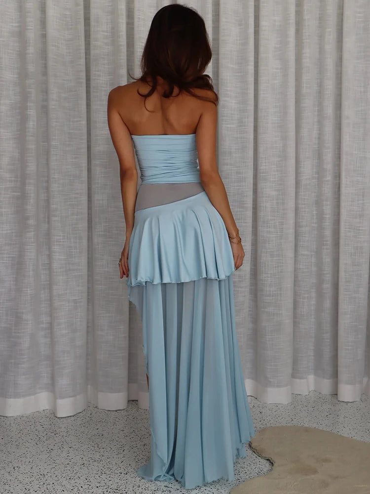 Woman wearing a light blue strapless dress with a gray belt - back