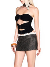 Women's black strapless spliced top with metal buckle detail.
