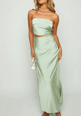 Woman wearing a light green strapless dress on a white background