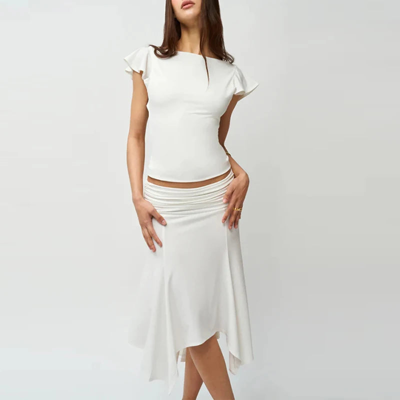 Woman wearing a white dress on a plain background