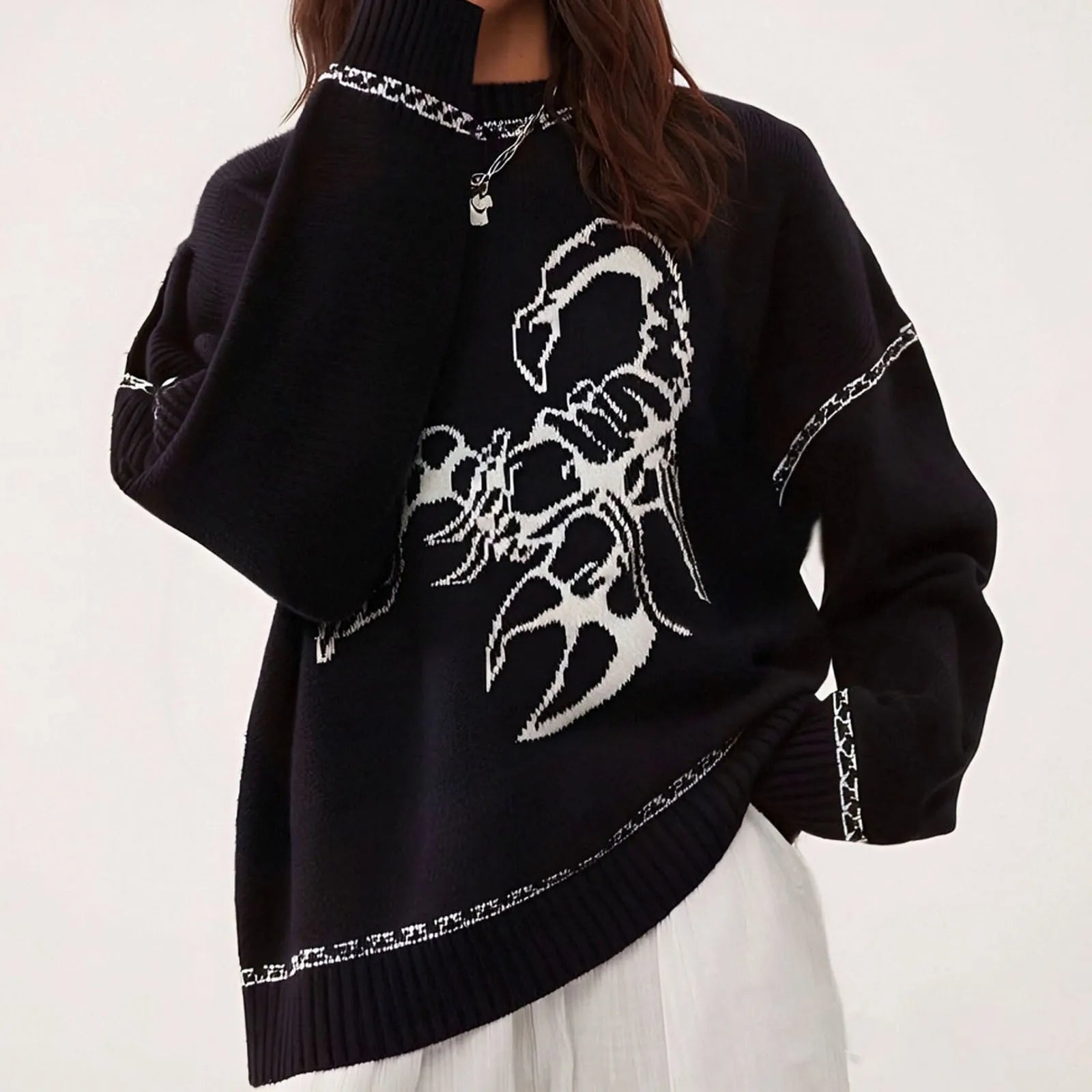 Black sweater with a white scorpion design on a white background