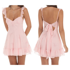 Model displaying a floral print mini dress with ruffles, straps, and an open back.