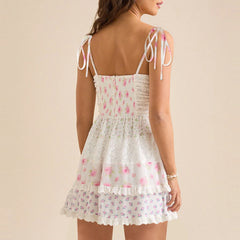 White floral dress with thin straps on a beige background- back view
